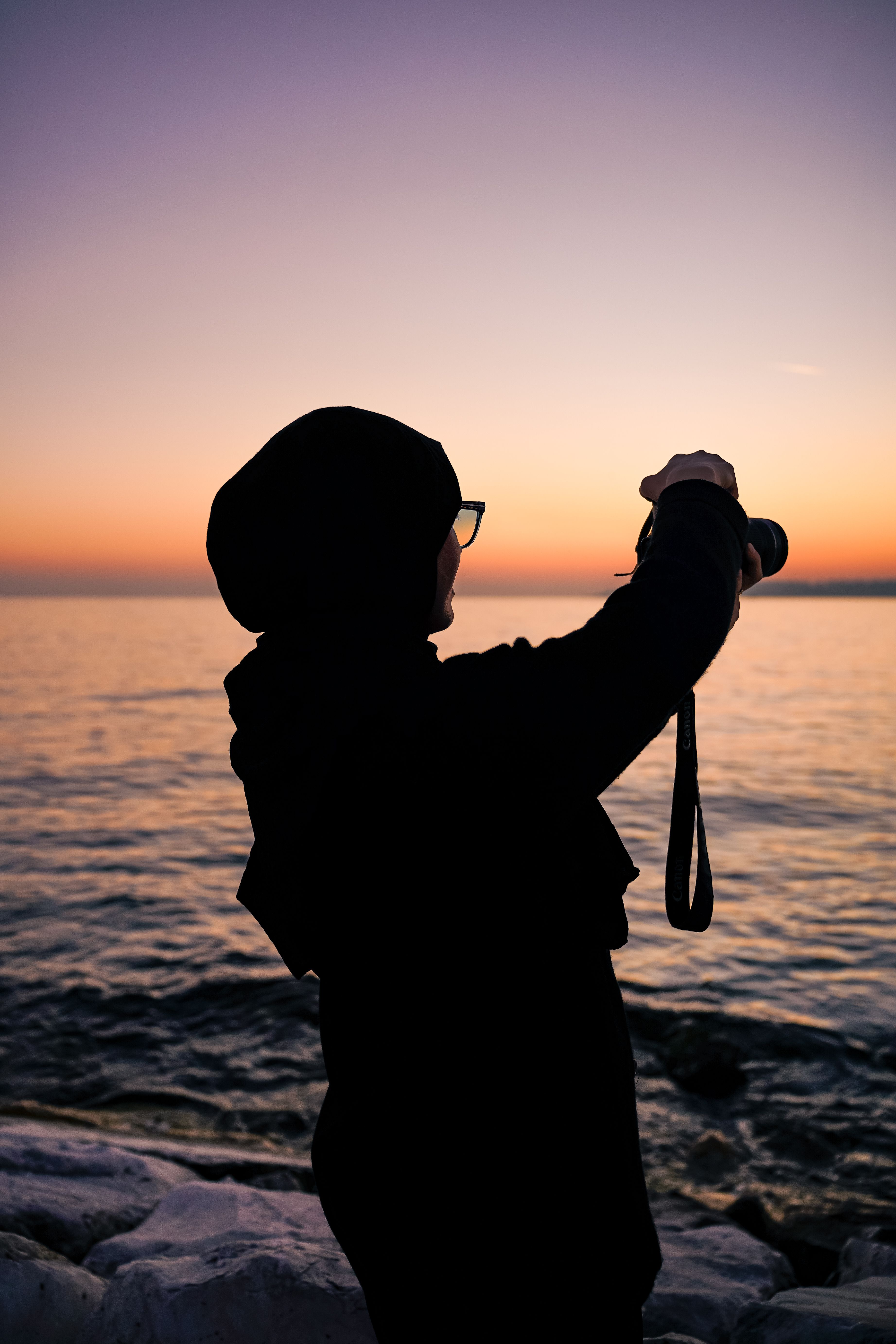 Silhouette of Photographer at Sunset by the Sea · Free Stock Photo