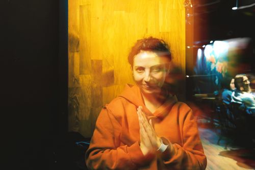 Free Artistic portrait of a woman with unique light effects in a cozy indoor setting. Stock Photo