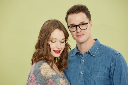 Free Chic couple posing with trendy eyeglasses against a pastel backdrop, showcasing fashion and style. Stock Photo