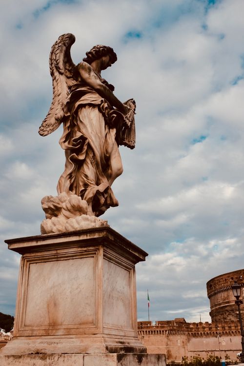 Free Statue of an angel with a musical instrument near Castel Sant'Angelo, Rome, Italy. Stock Photo