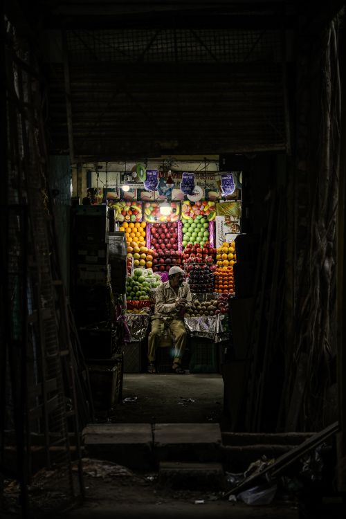 Free A vibrant fruit shop in a narrow alley at night in Bengaluru, India. Stock Photo