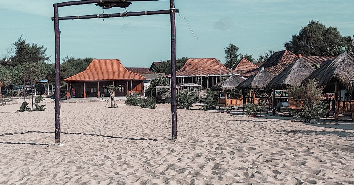 A traditional wooden spoon stirring a large paella pan filled with colorful rice, vegetables, and seafood.