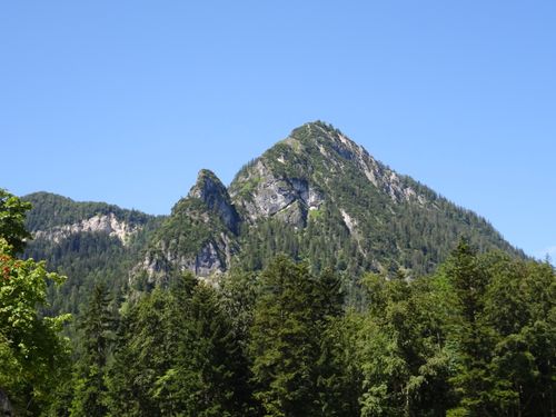 Free Breathtaking view of a lush green mountain landscape against a clear blue sky. Stock Photo