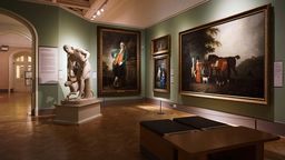 A museum room hung with classical works