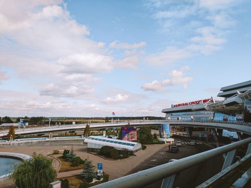 Free Wide view of Minsk National Airport with clear skies, showcasing airport architecture and surroundings. Stock Photo