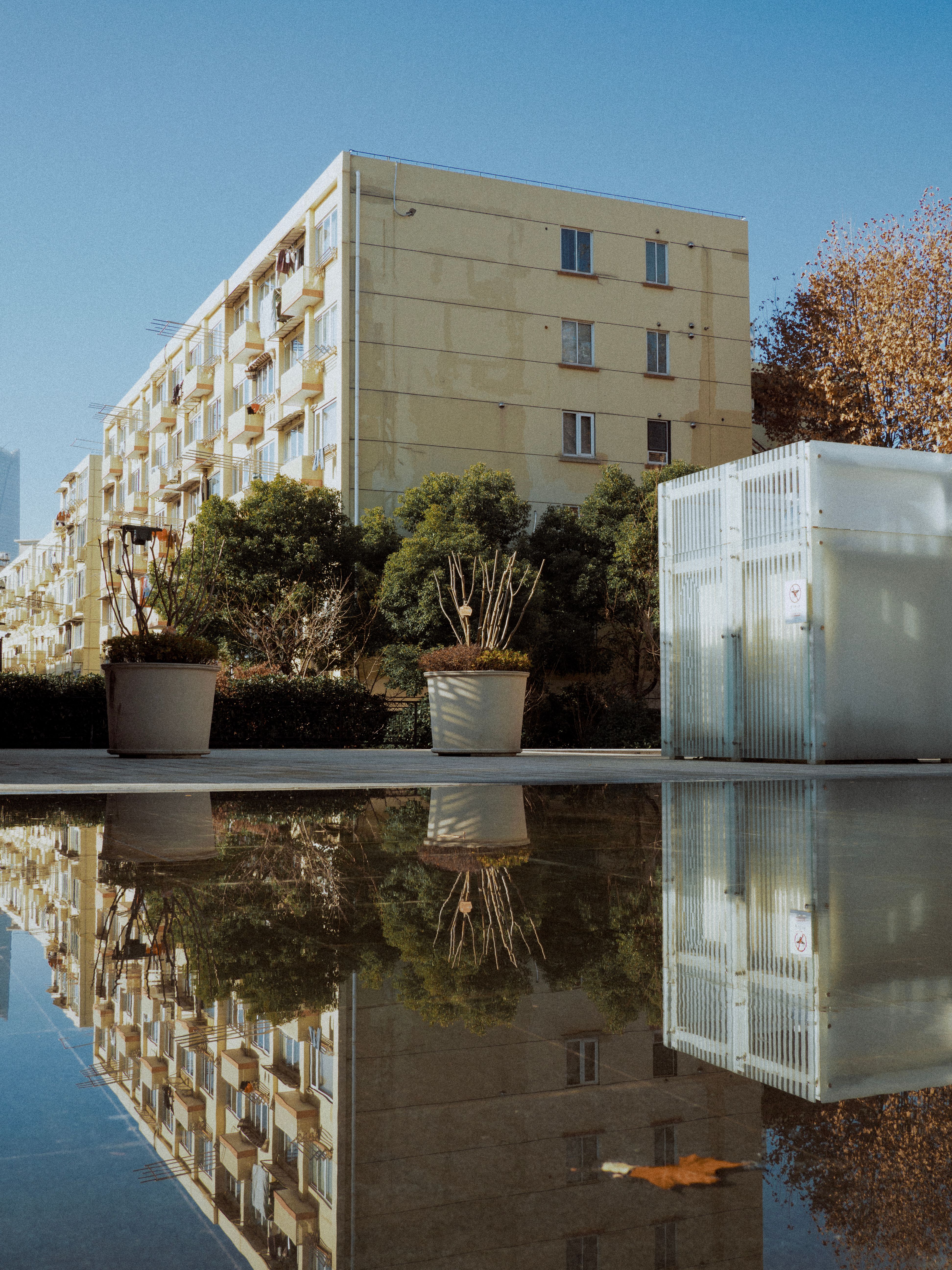 Modern Urban Apartment Reflection in Water · Free Stock Photo