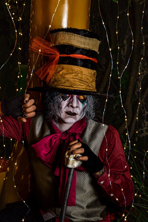 Free Mad Hatter cosplay surrounded by enchanting lights, showcasing vibrant colors and intricate details. Stock Photo