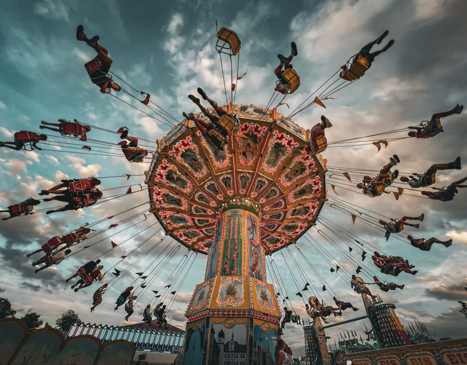 Colorful Carnival Ride Against Dramatic Sky ยท Free Stock Photo
