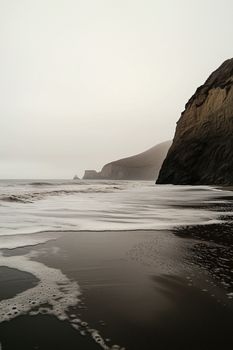Foggy seascape with crashing waves and towering cliffs in Spain's CN region.