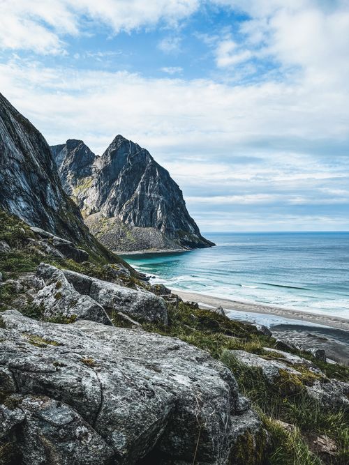 Free Breathtaking view of rocky cliffs and turquoise sea along a Norwegian coastline. Stock Photo