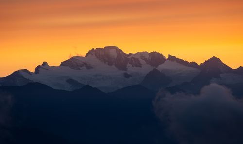 Free Stunning view of Grivola Peak at sunset in Aosta Valley, Italy, with dramatic lighting and vibrant colors. Stock Photo