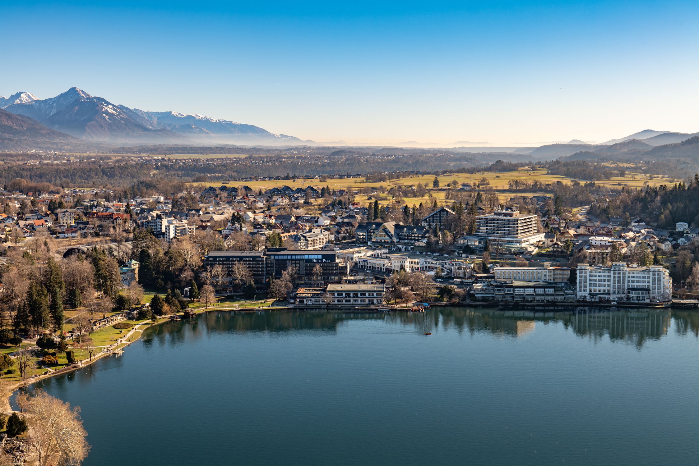 A stunning aerial view of the town of Bled in Slovenia, featuring Lake Bled and surrounding mountains.