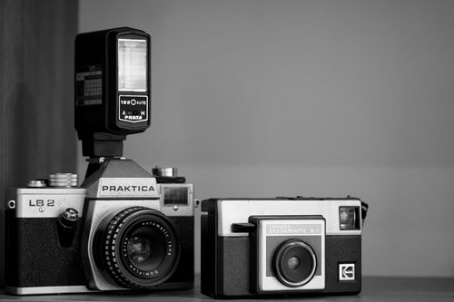 Free Close-up of vintage Praktica and Instamatic cameras with flash. Stock Photo