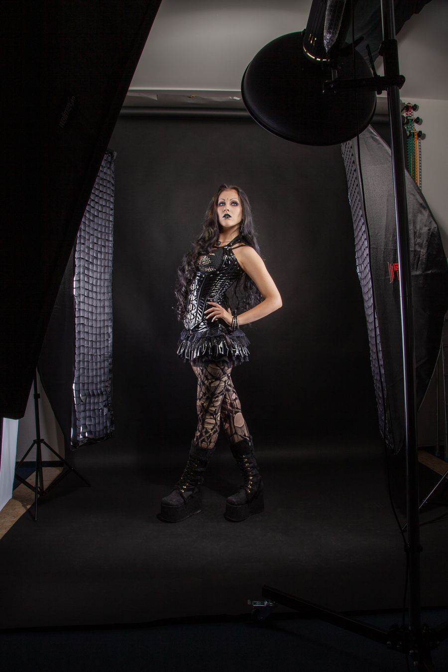 Model lit by a single studio lamp on a dark set
