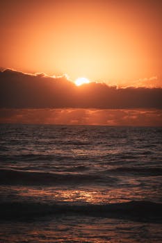 Breathtaking sunrise over the ocean at Nuevo Vallarta, showcasing vivid colors and serene waves.