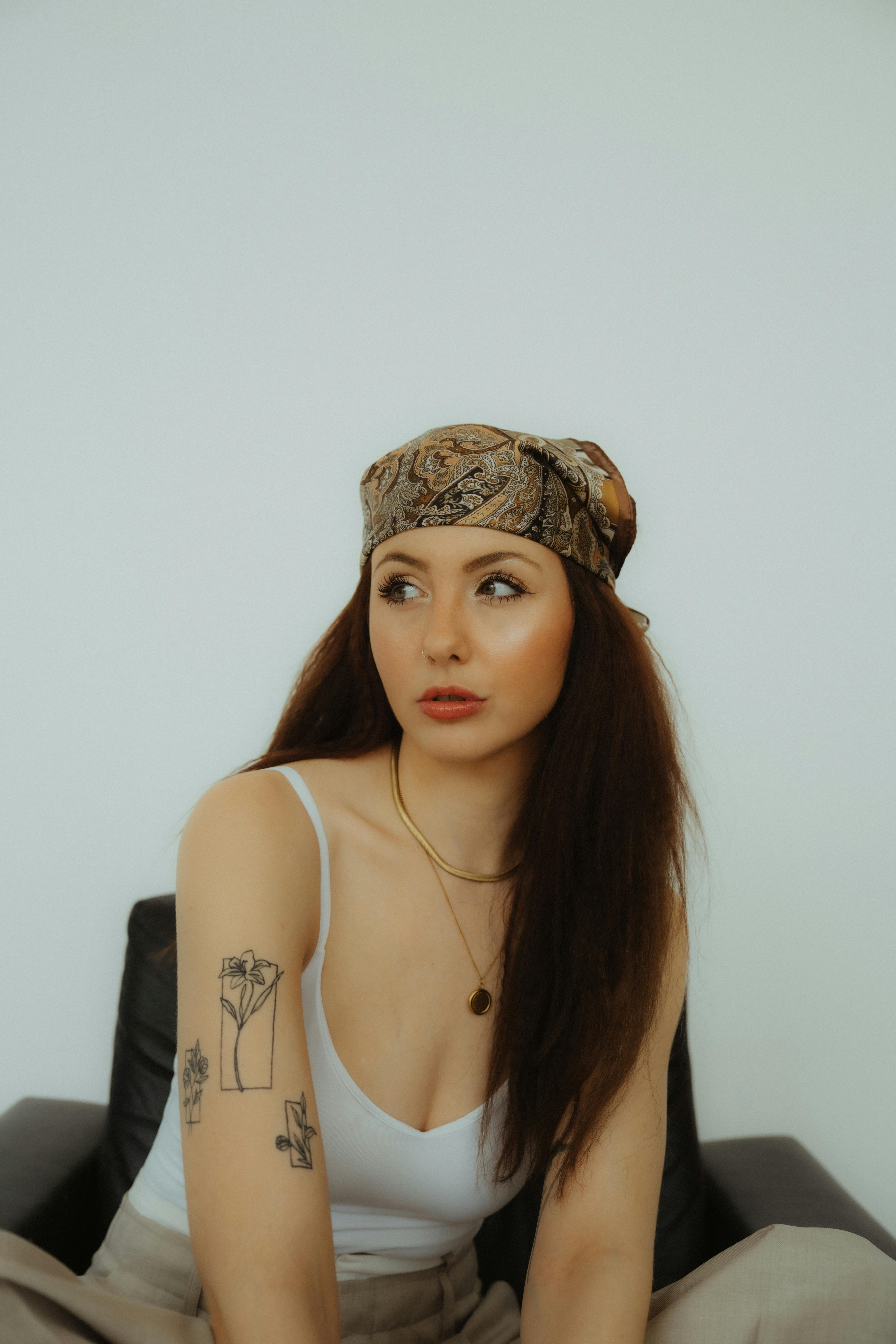 portrait of woman with headscarf and tattoos