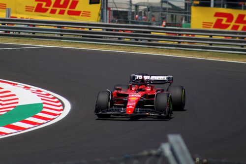Free Ferrari F1 car racing at the Hungarian Grand Prix, showcasing thrilling motorsport action. Stock Photo
