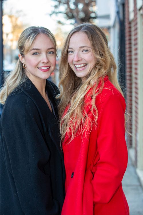 Free Two women smiling warmly outdoors in stylish winter coats. Stock Photo