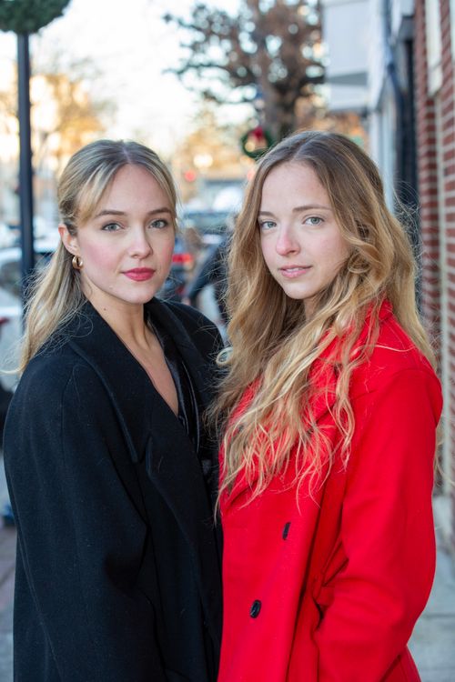 Free Two young women pose stylishly in an urban setting, exuding confidence and elegance. Stock Photo