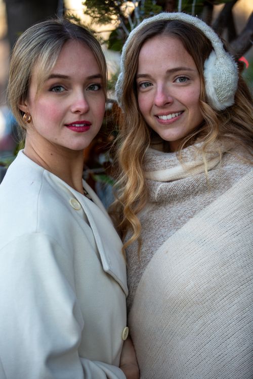 Free Two women in winter fashion pose outdoors, radiating warmth and style. Stock Photo
