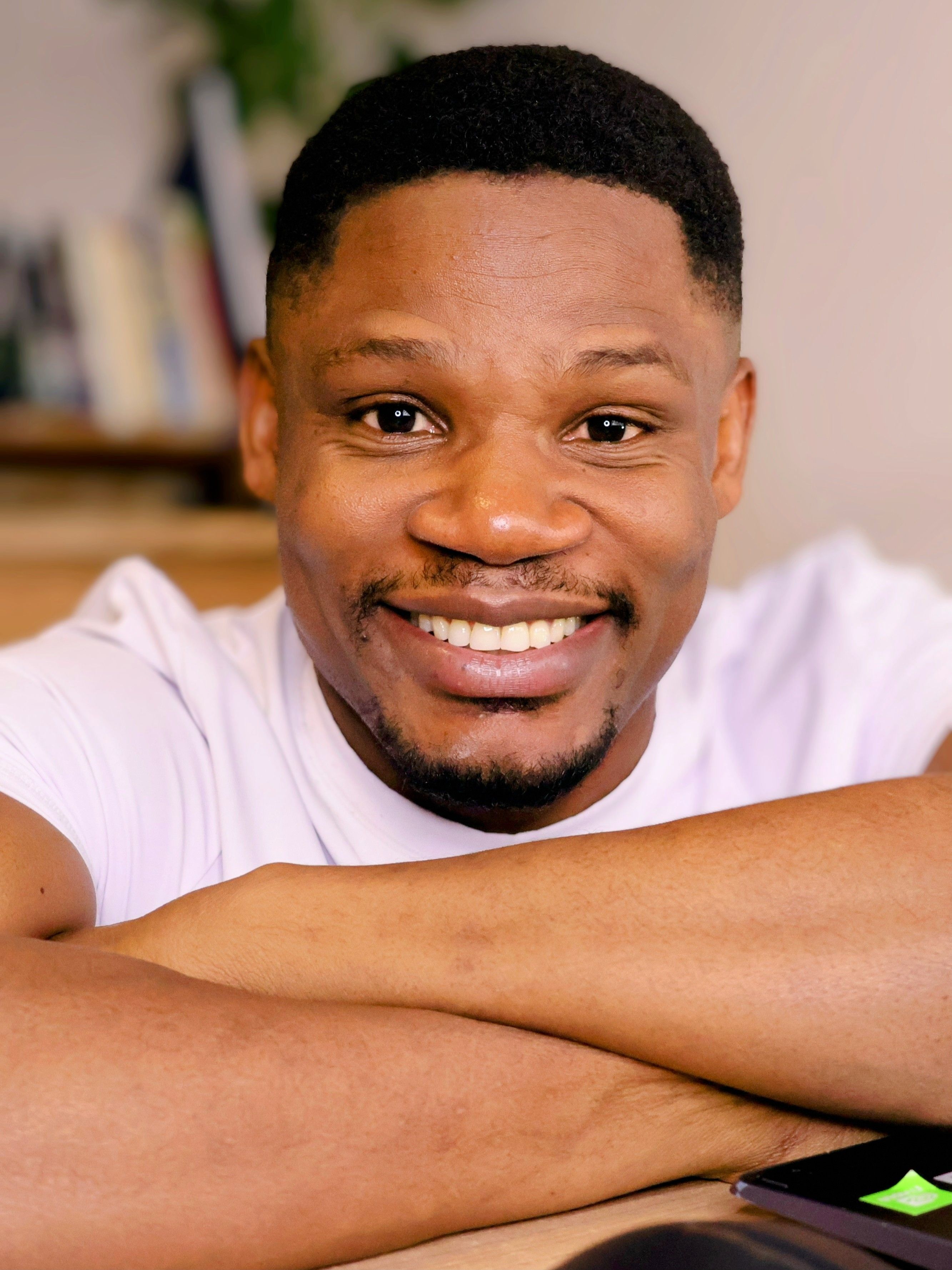 A cheerful man with a warm smile relaxing in his home in Hatfield, UK.