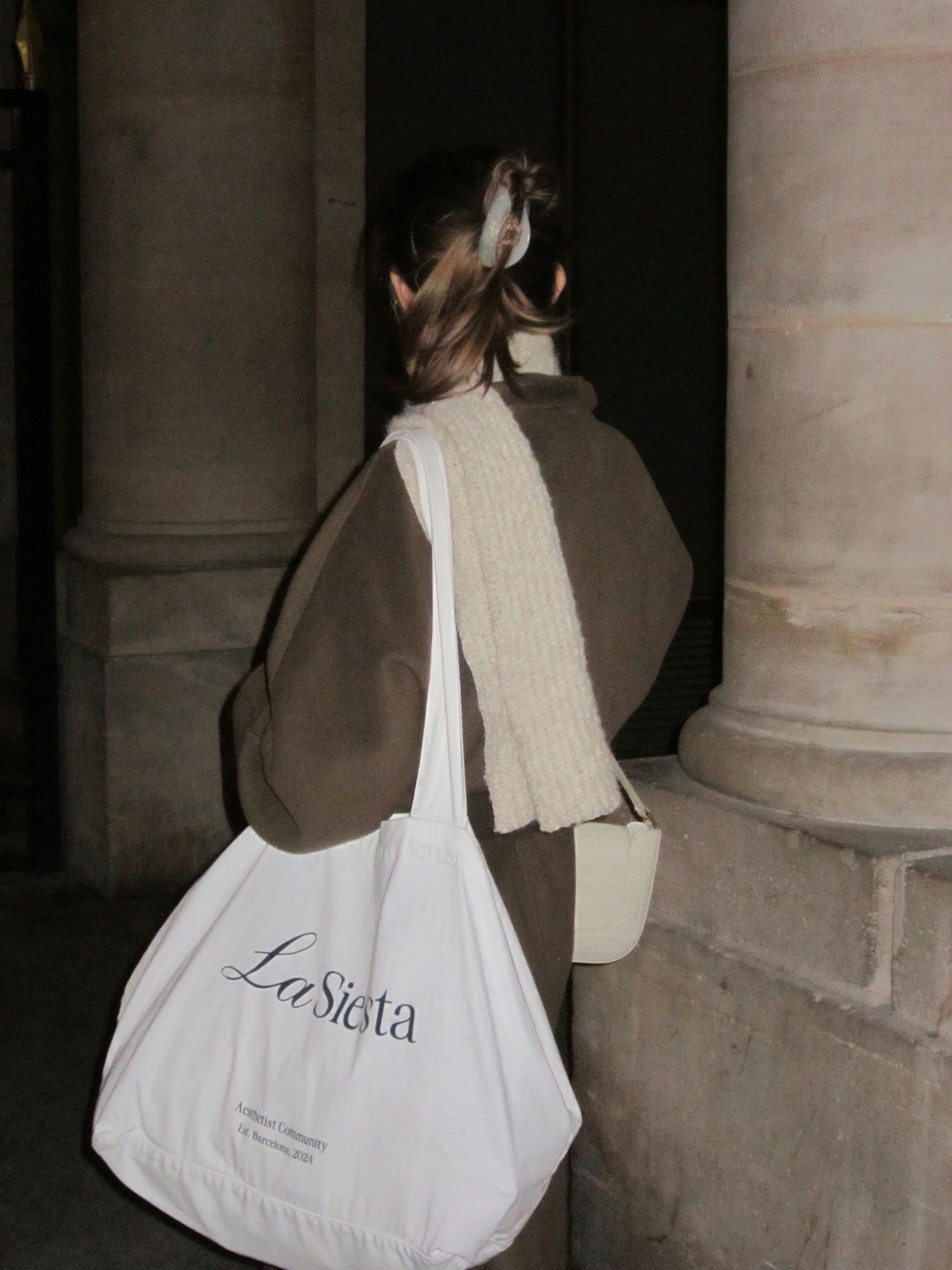 Fashionable woman with tote bag in urban environment, stylish and modern.