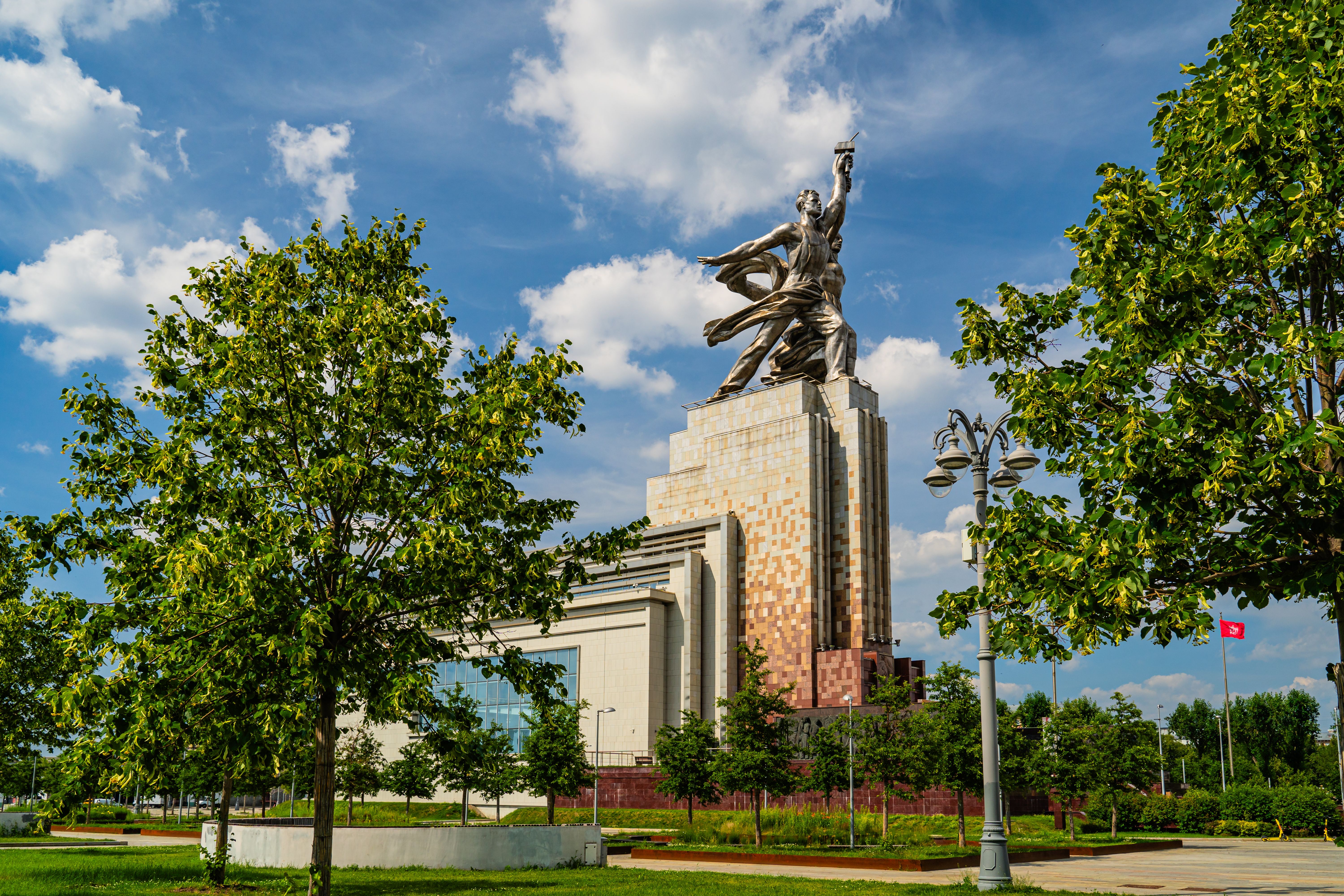 Iconic Soviet sculpture representing industrial and agricultural labor in urban setting.