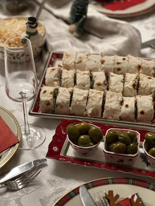 Free Elegant holiday table with appetizers, olives, and wine glass. Perfect for festive gatherings. Stock Photo