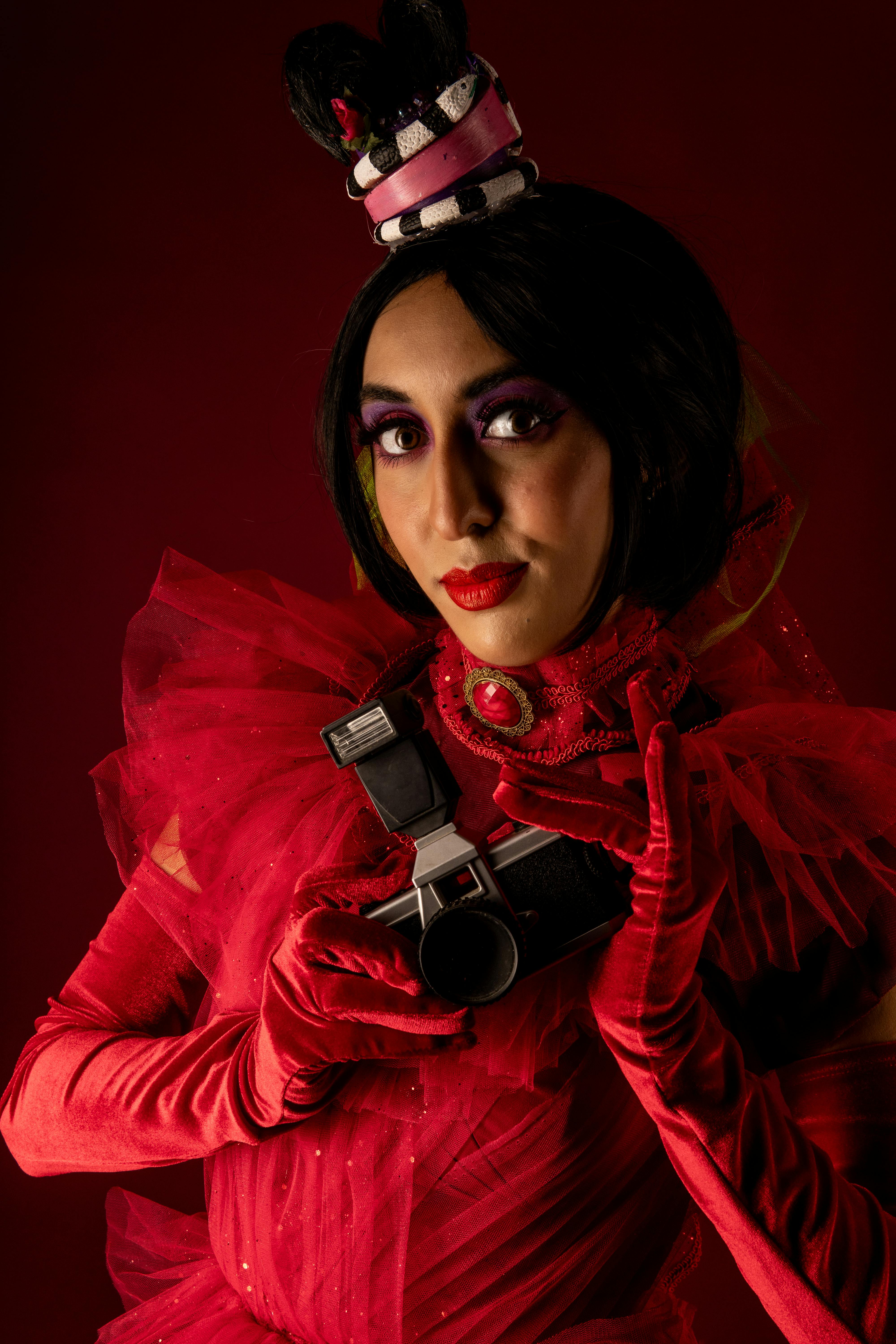 Ücretsiz Gösterişli bir kostüm giymiş ve elinde eski bir kamera tutan bir karakterin yer aldığı dramatik bir cosplay portresi. Stok Fotoğraflar