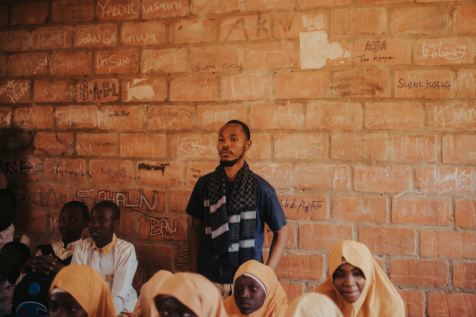 African teacher with students in a classroom