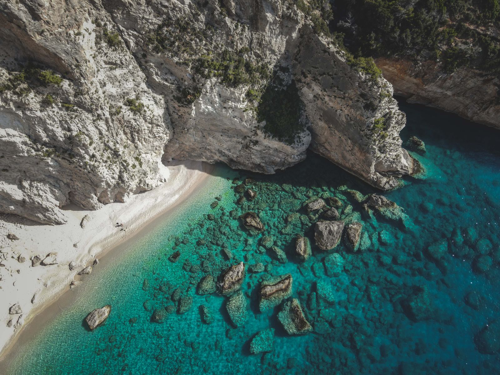 Aerial view of Sardinian coastline with crystal-clear turquoise water