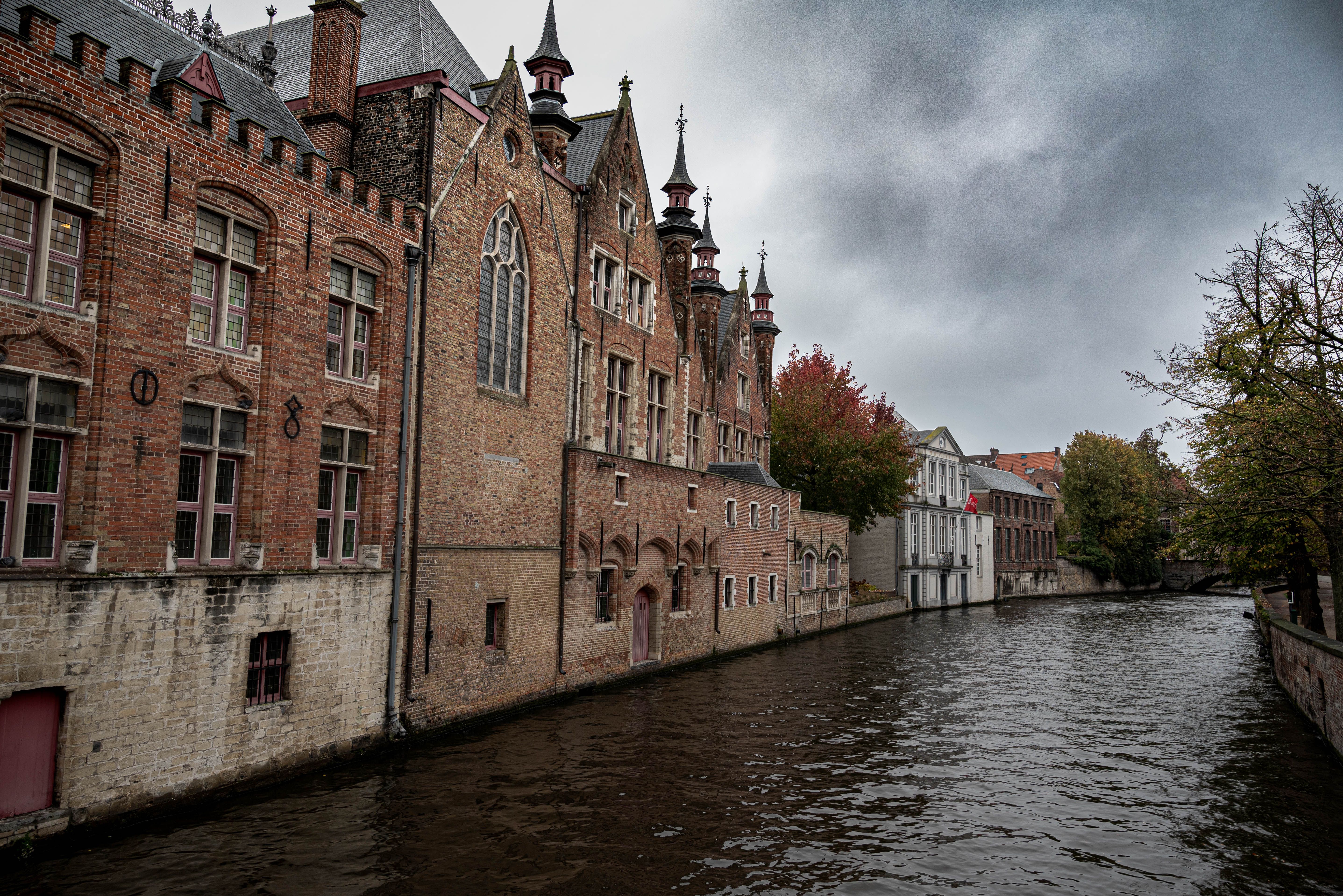 Atmospheric view of a historic canal and old town architecture in Ghent, Belgium. — photo by NIKOLAOS IOANNIDIS / Pexels