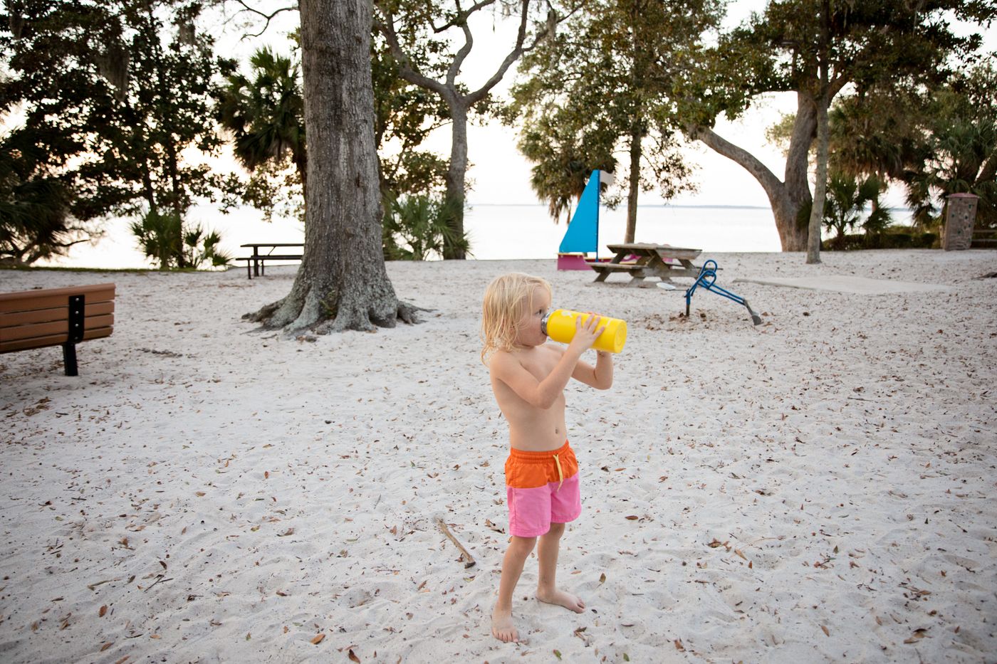 Young child drinking water in sunny weather