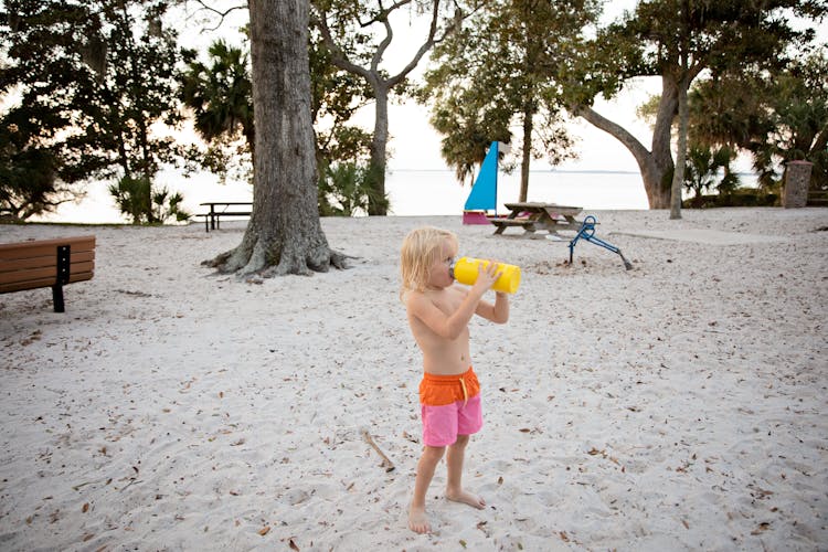 Boy Drinking With Yellow Bottle