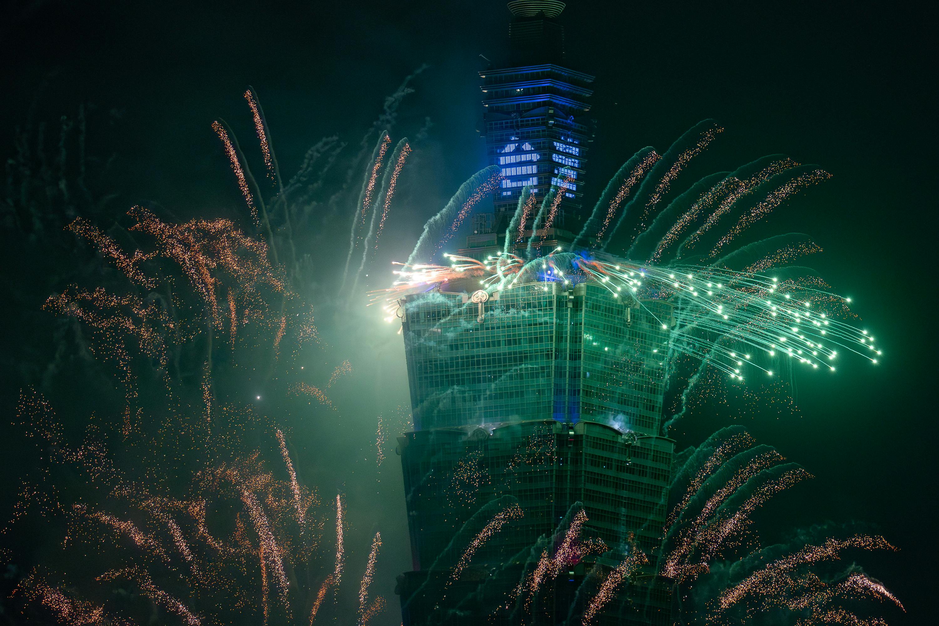 New Year fireworks display illuminating Taipei 101 in Taiwan at night.