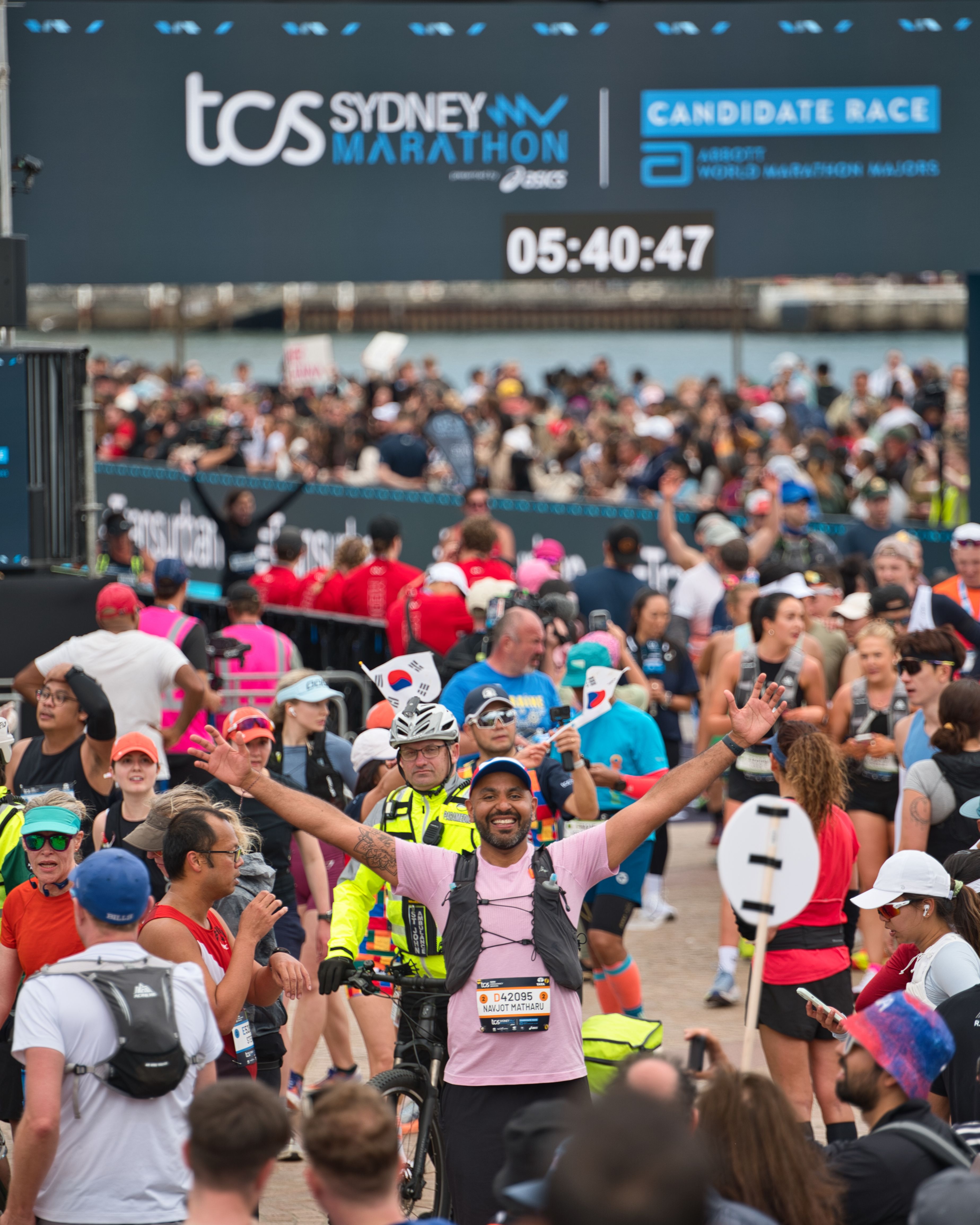 Joyful participants crossing the finish line at the Sydney Marathon, capturing the thrill of the moment.
