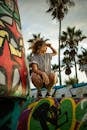 Photo of Woman Squatting on Graffiti Wall Posing While Looking Away