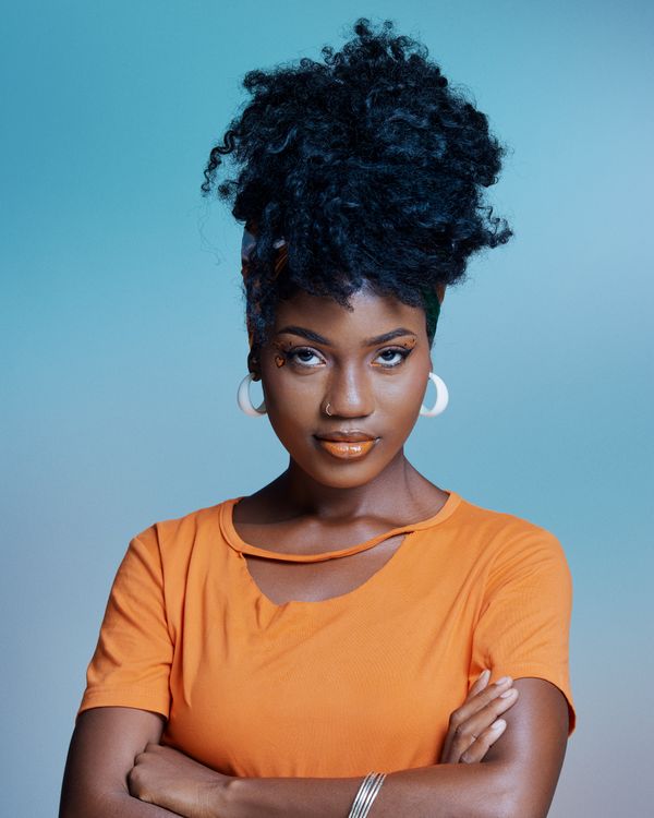 Stylish Woman in Orange Top with Natural Hair · Free Stock Photo