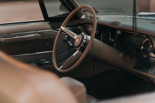 Close-up of a classic car's steering wheel in Abu Dhabi, UAE.