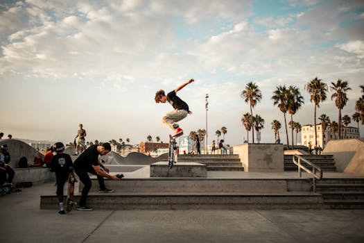 Skateboarder performs tricks at Venice Beach Skatepark in Los Angeles, CA, during the golden hour.