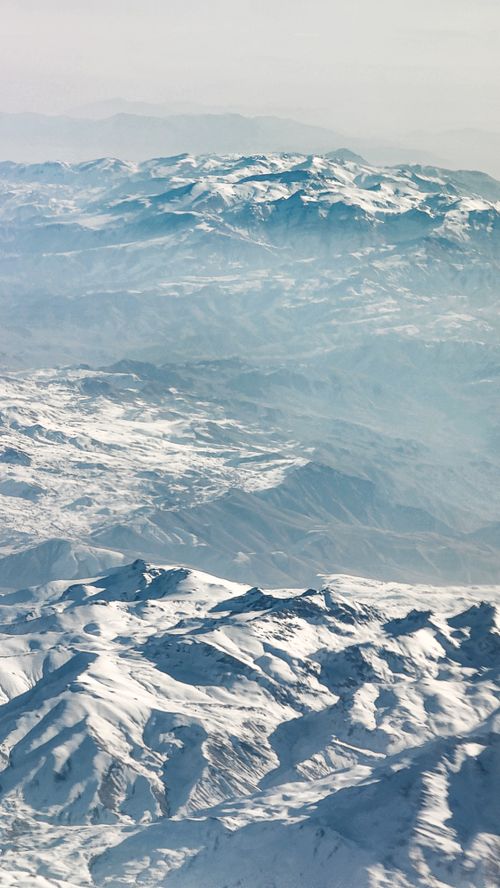 Free Stunning aerial view of snow-covered mountains in Iran, showcasing winter beauty. Stock Photo