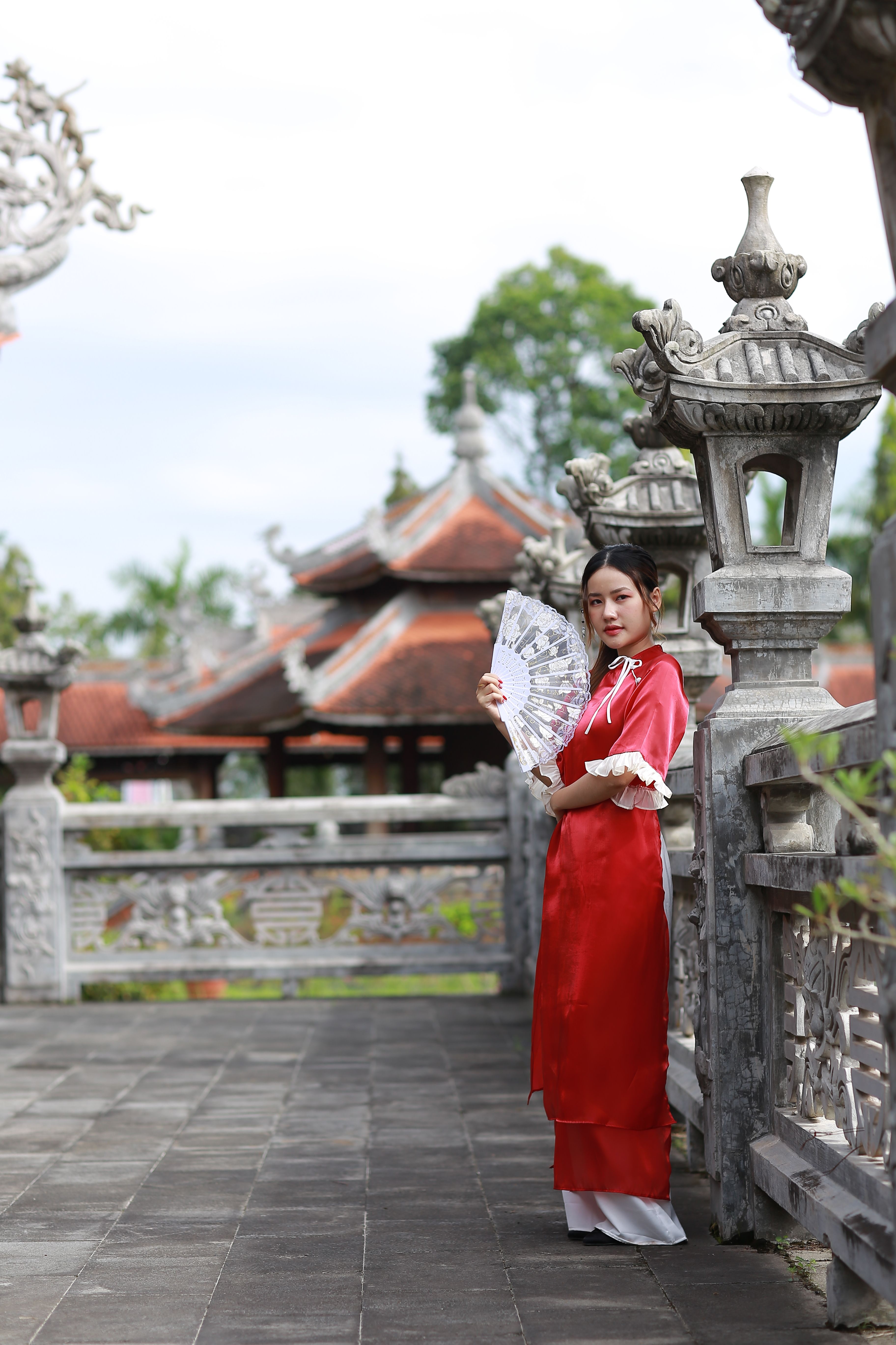 Woman in Traditional Dress with Hand Fan Outdoors · Free Stock Photo