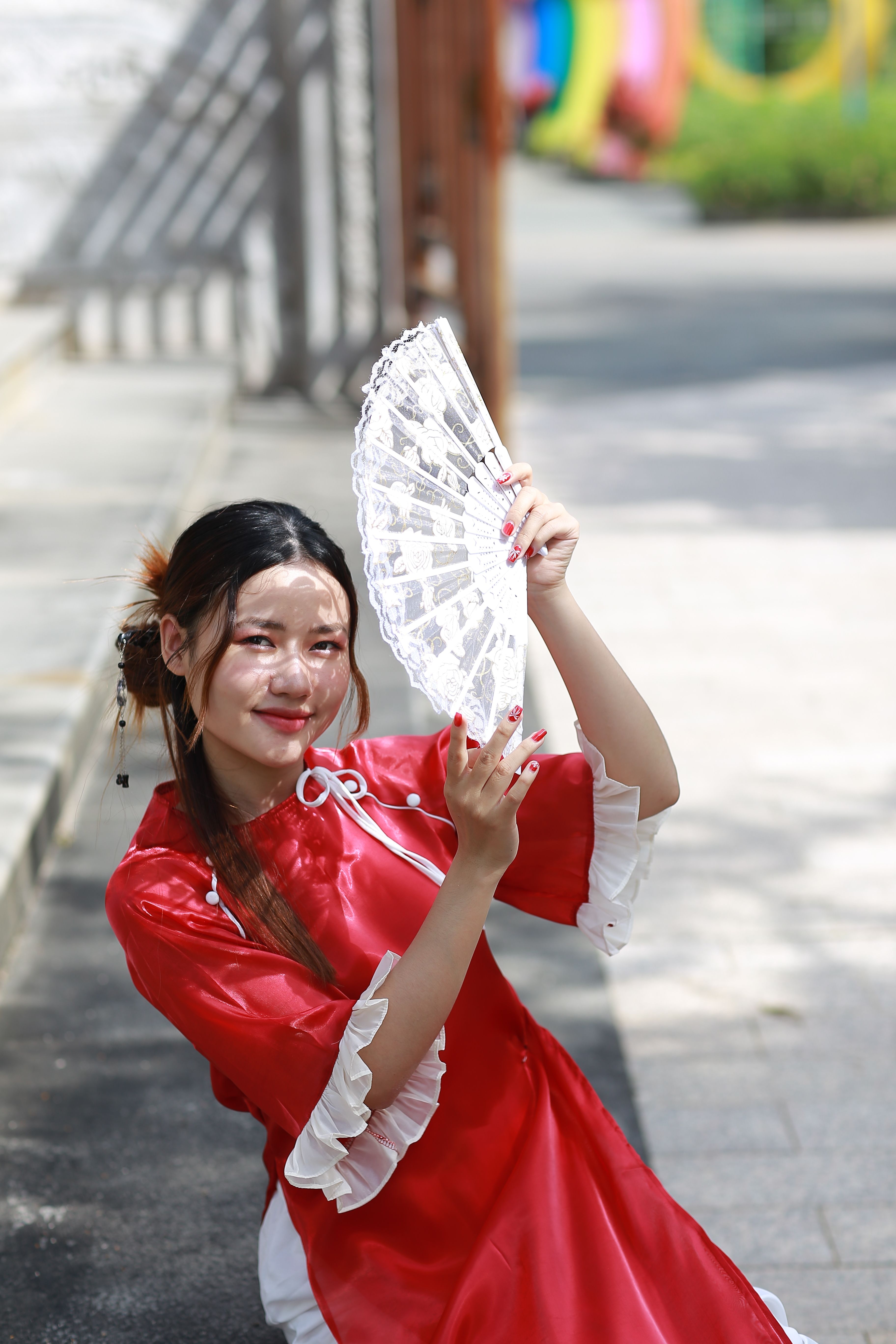 Young Woman in Red Dress with Lace Fan Outdoors · Free Stock Photo