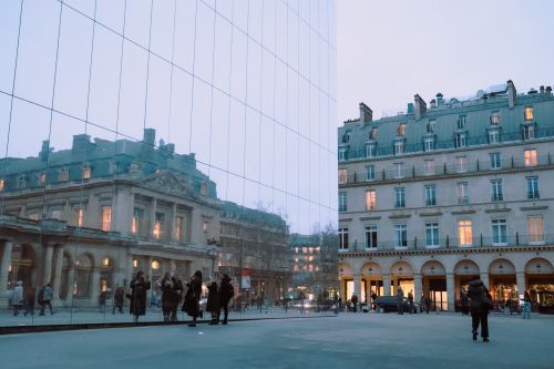 Free A reflective view of Paris architecture and city life captured at dusk, showcasing classic beauty. Stock Photo