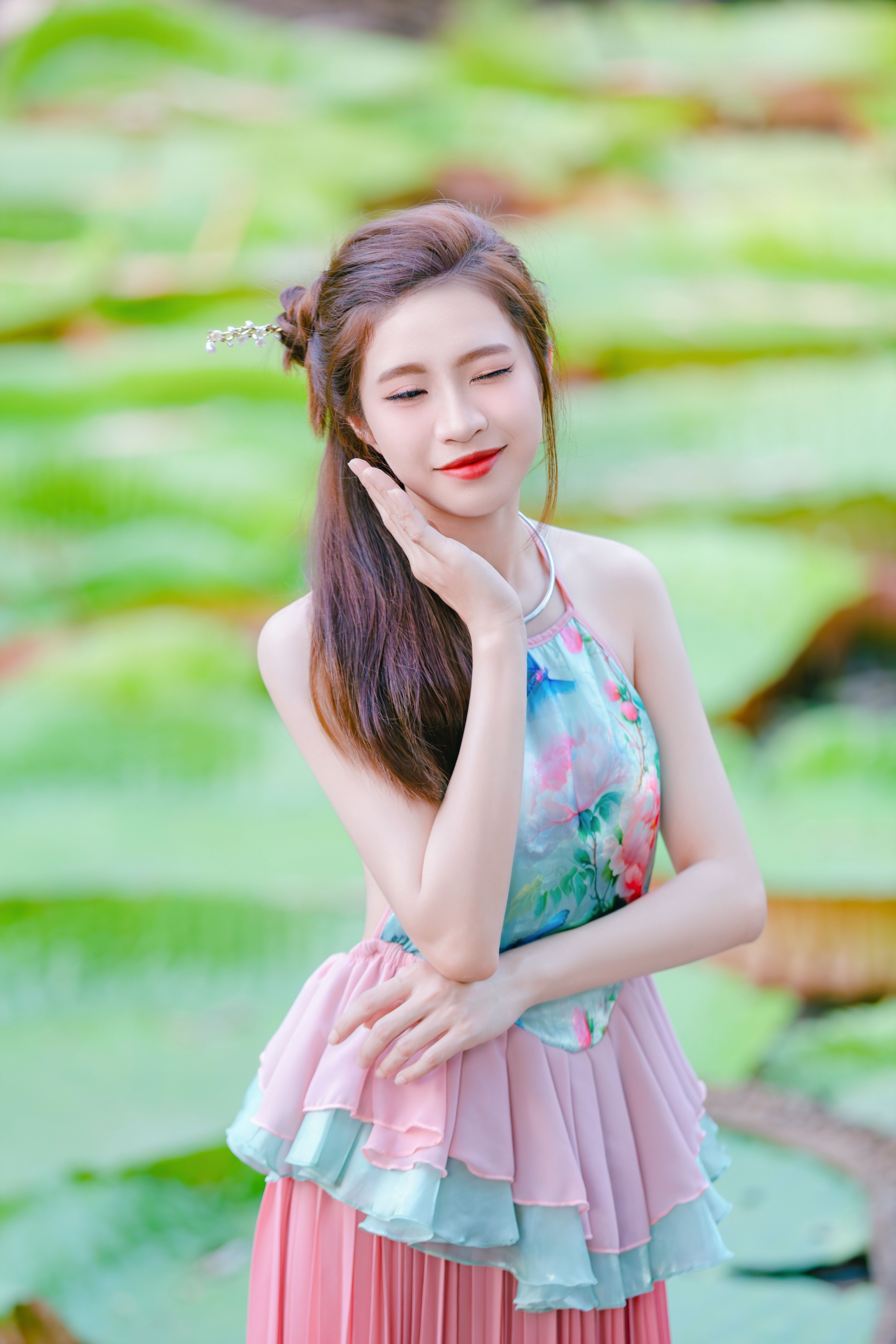 Elegant Woman Posing in Floral Dress by Lotus Pond · Free Stock Photo