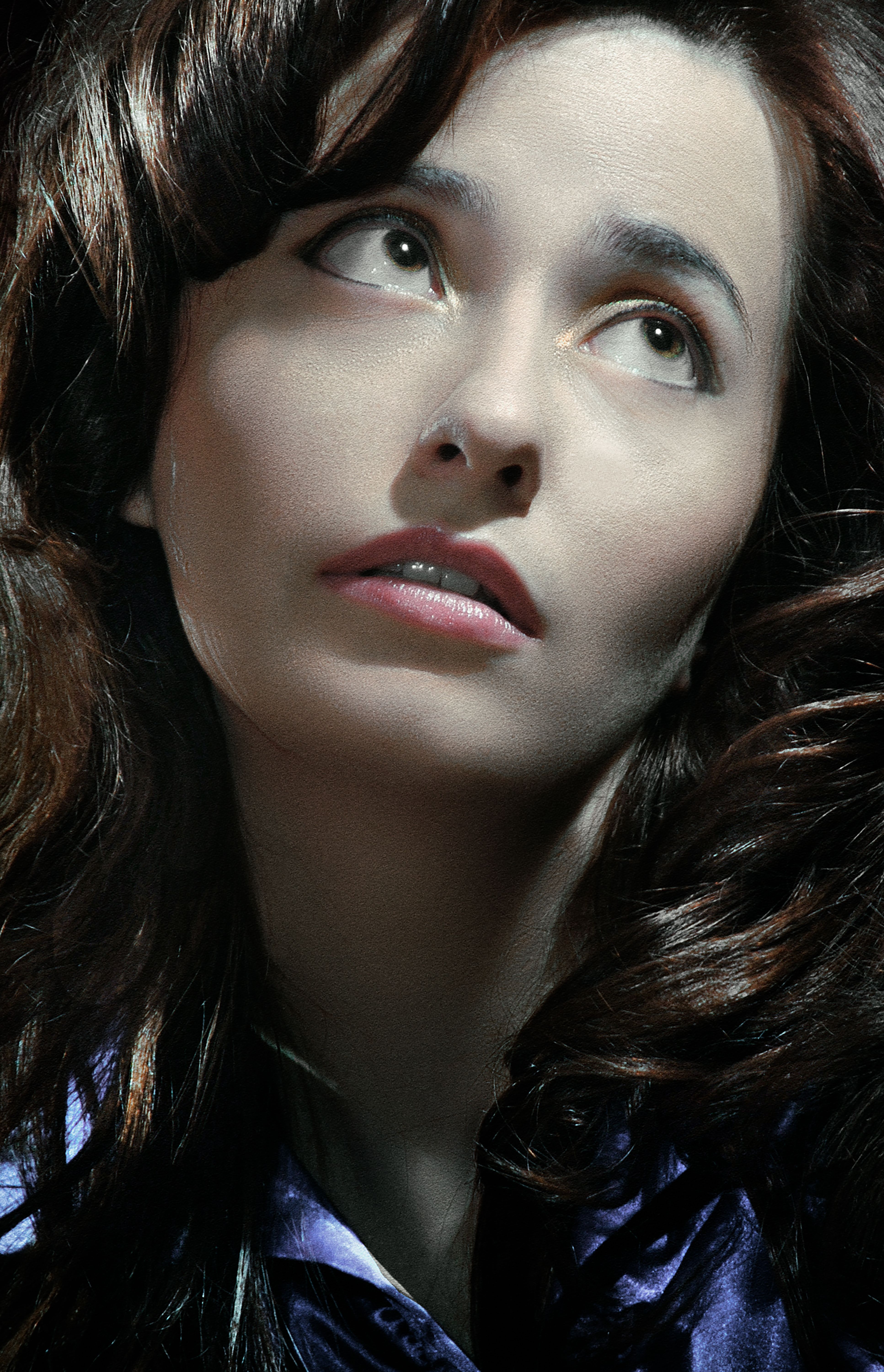 Close-up portrait of a woman with dark hair looking upwards, captured in Kyiv.