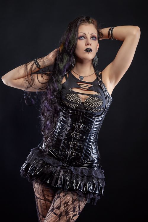 Free Striking portrait of a woman in gothic attire featuring a black leather corset and intricate accessories. Stock Photo