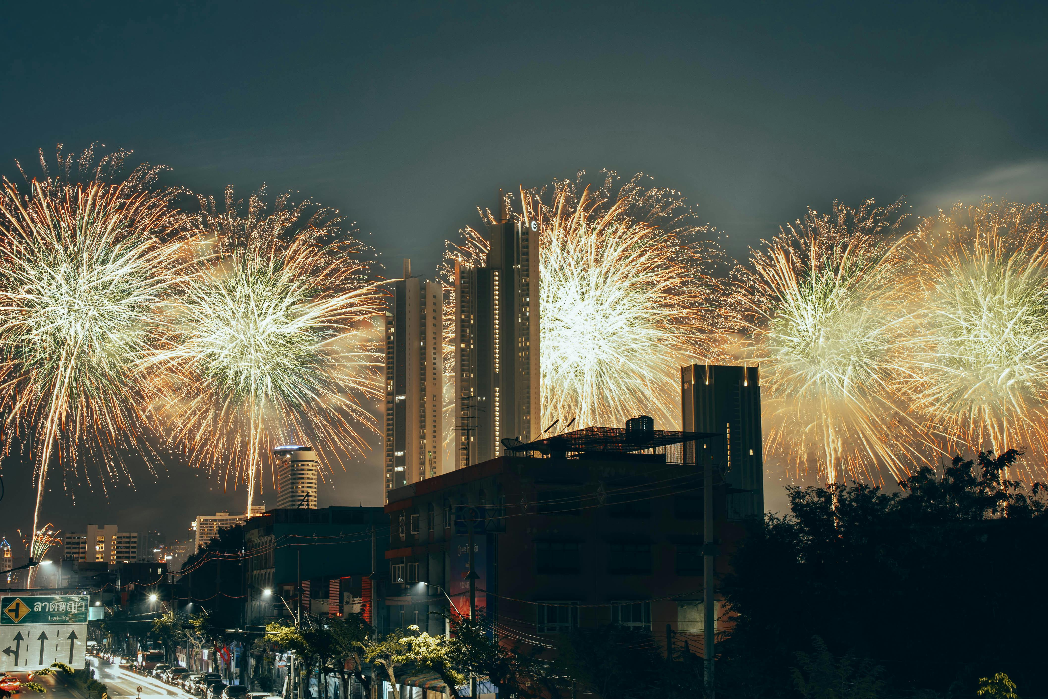 Vibrant fireworks light up the Bangkok skyline, celebrating New Year in Thailand's capital city.