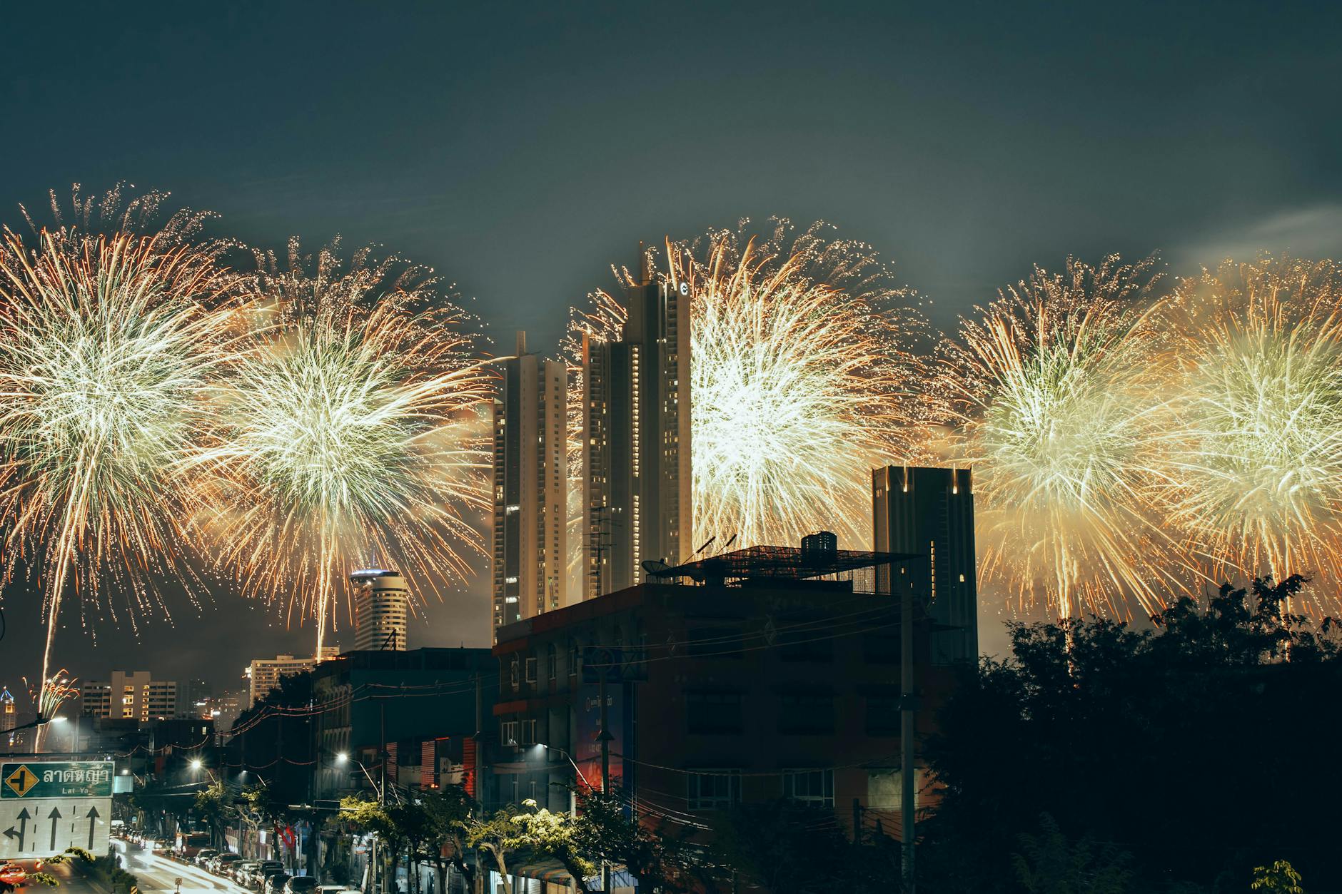 Vibrant fireworks light up the Bangkok skyline, celebrating New Year in Thailand's capital city.