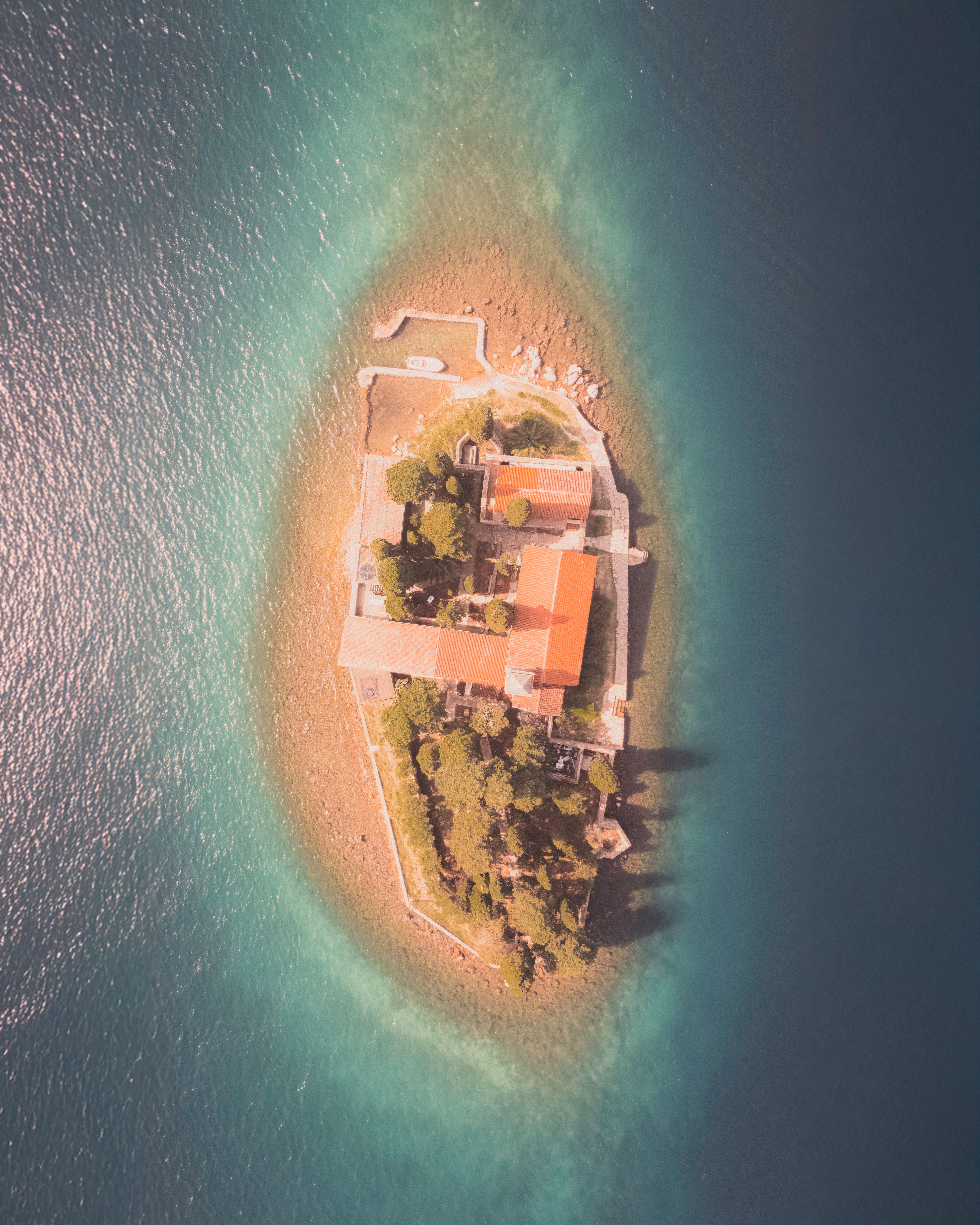 Aerial View of Idyllic Island Surrounded by Azure Waters · Free Stock Photo